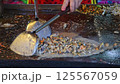 Fried mussel pancakes or Mussel fried in egg batter (Hoi Tod) for sale at Thai street food market or restaurant in Thailand 125567059