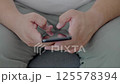 Dubai, UAE- 25.04.2025: Adult male using OPEN AI ChatGPT on a smartphone. Artificial intelligence technology. Smartphone closeup. Male hands using AI on phone. High quality 4k footage 125578394