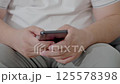 Dubai, UAE- 25.04.2025: Adult male using OPEN AI ChatGPT on a smartphone. Artificial intelligence technology. Smartphone closeup. Male hands using AI on phone. High quality 4k footage 125578398