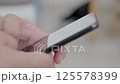Dubai, UAE- 25.04.2025: Adult male using OPEN AI ChatGPT on a smartphone. Artificial intelligence technology. Smartphone closeup. Male hands using AI on phone. High quality 4k footage 125578399