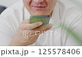 Dubai, UAE- 25.04.2025: Adult male using OPEN AI ChatGPT on a smartphone. Artificial intelligence technology. Smartphone closeup. Male hands using AI on phone. High quality 4k footage 125578406