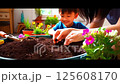 A family planting together at home during springtime, with a warm and cheerful atmosphere 125608170