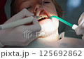 Close-up of a young boy receiving an ultrasonic dental cleaning at the dentist office. Two dental 125692862