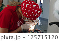 Close-up of a young boy receiving an ultrasonic dental cleaning at the dentist office. Two dental 125715120