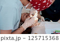 Young female dentist treats a woman patient in a bright, modern dental clinic. She works with 125715368