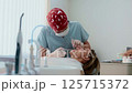 Young female dentist treats a woman patient in a bright, modern dental clinic. She works with 125715372