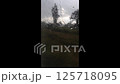 Blurry image of a field with a few trees and a person in the foreground 125718095