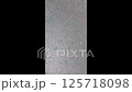 Black and white photo of a sidewalk with a green substance on it 125718098