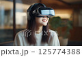A woman experiencing virtual reality 125774388