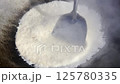 Asian cook is cooking in thai kitchen in local traditional country style, preparing sizzling thai green curry paste being stir fried in traditional wok to cook thai food green curry popular worldwide 125780335