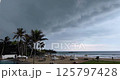 Real time footage of looming thunderclouds rolling over a tropical beach during an incoming storm 125797428
