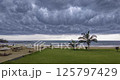 Dramatic timelapse of fast moving thunderstorm clouds sweeping across a tropical coastline 125797429