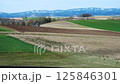 Biei: Tractor plowing the hills 125846301