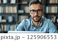 Professional man working intently on laptop in modern office setting 125906553