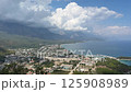 Aerial view of the city on the seashore.Town by the sea. Mountains in the background. 125908989