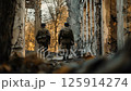 Two weary soldiers walk through the ruins of a wartorn building, reflecting on their journey and experiences Two weary soldiers walk through the ruins of a wartorn building, reflecting on their journey and experiences 125914274