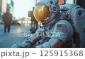 An astronaut is sitting on a bustling downtown city street during daylight, creating a surreal and imaginative scene An astronaut is sitting on a bustling downtown city street during daylight, creating a surreal and imaginative scene 125915368