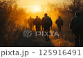 A group of soldiers marching together into the beautiful sunset along a dusty trail evokes strong emotions A group of soldiers marching together into the beautiful sunset along a dusty trail evokes strong emotions 125916491