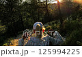 Young girl walking on a path at sunset in a forest 125994225