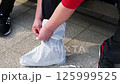 砂防止シューズカバーを履いている様子 125999525