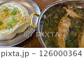 Culinary flavorful experience featuring white taramas dip called taramosalata and grilled squid on broth, served with vegetables. 126000364