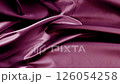 A silk-textured background made of grape color fabric.  126054258