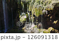 Pristine water cascading over moss-covered stones, forming enchanting waterfall scene nestled in lush turkish landscape 126091318