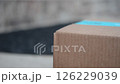 Quiet Delivery Moment - Blurred Pickup of a Package at the Doorstep 126229039