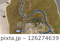People observe intricate large-scale model depicting diverse terrain features. Winding river, greenfield, industrial structure impressive model. Detailed model unique perspective landscape planning. 126274639