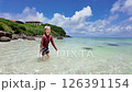 Joyful Child Splashing Water In Slow Motion On A Sunny Tropical Beach, Fun Summer Vacation Moment 126391154
