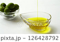 白背景でエキストラバージンオリーブオイルを注ぐ 126428792