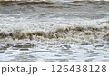 dirty water and big waves at sea during the monsoon season. Slow motion 126438128