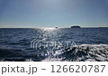 sparkling sea under clear sky with distant boat 126620787
