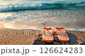 Yellow flip flops on sandy ocean tropical beach with sea wave and blue sky 126624283