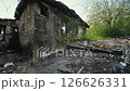 House is in ruins with a lot of debris and a window 126626331