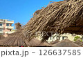 Rustic straw umbrella at a beach resort conveys warmth and tropical leisure, suited for travel promos, summer ads, and coastal living blogs. Rustic straw umbrella at a beach resort conveys warmth and tropical leisure, suited for travel promos, summer ads, and coastal living blogs. 126637585