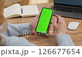 Woman sit use digital tech cell phone open green screen mock up. Hand scroll phone web site swipe unlock. Girl hold mobile closeup. Turn on chroma key page Cozy home background. Online app copy space 126677654