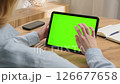 Woman sit desk use click digital tech tablet, green screen mock up. Hand swipe pad web site. Girl hold pad closeup press tap touch middle. Chroma key page. Cozy home background. Online app copy space 126677658