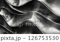 Close-up black and white animation of an abstract wave with a flat surface, styled metallically. It features photobashing, glossy details, reflective soft-edged drapery in an abstract creation.	 126753530
