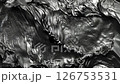 Black and white close-up of an abstract wave with a flat surface, in a metallic style. It features photobashing, shiny, glossy details, reflective, soft-edged drapery in an abstract creation.	 126753531