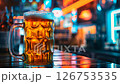 A cup of beer under neon bar lights.	 126753535