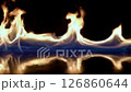 Abstract Flames Dancing Against Black Background with Blue Reflection Effect 126860644