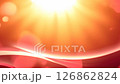 Sunlight shining through the sun ' s rays on a red background 126862824