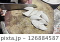 Asian cook is cooking in thai kitchen in local traditional country style, preparing fresh fish balls to cook thai food green curry popular worldwide 126884587