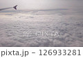 Cloud in sky. Airplane flight in white cloud at sky. Fly in soft clouds, looking from air plane window 126933281