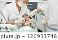 Young patient receives a dental check-up in a modern clinic, with professionals examining and treating oral health 126933748