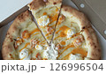Taking slice of tasty pizza with shrimps, creamy cheese, and sauce in opened cardboard box. Pizza time. Delicious fast food cuisine. 126996504