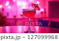 Pink cocktail with a umbrella on a table 127099968