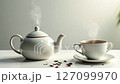 Tea pot and a cup of coffee on a table 127099970