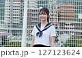 Smiling high school girl standing on the roof 127123624